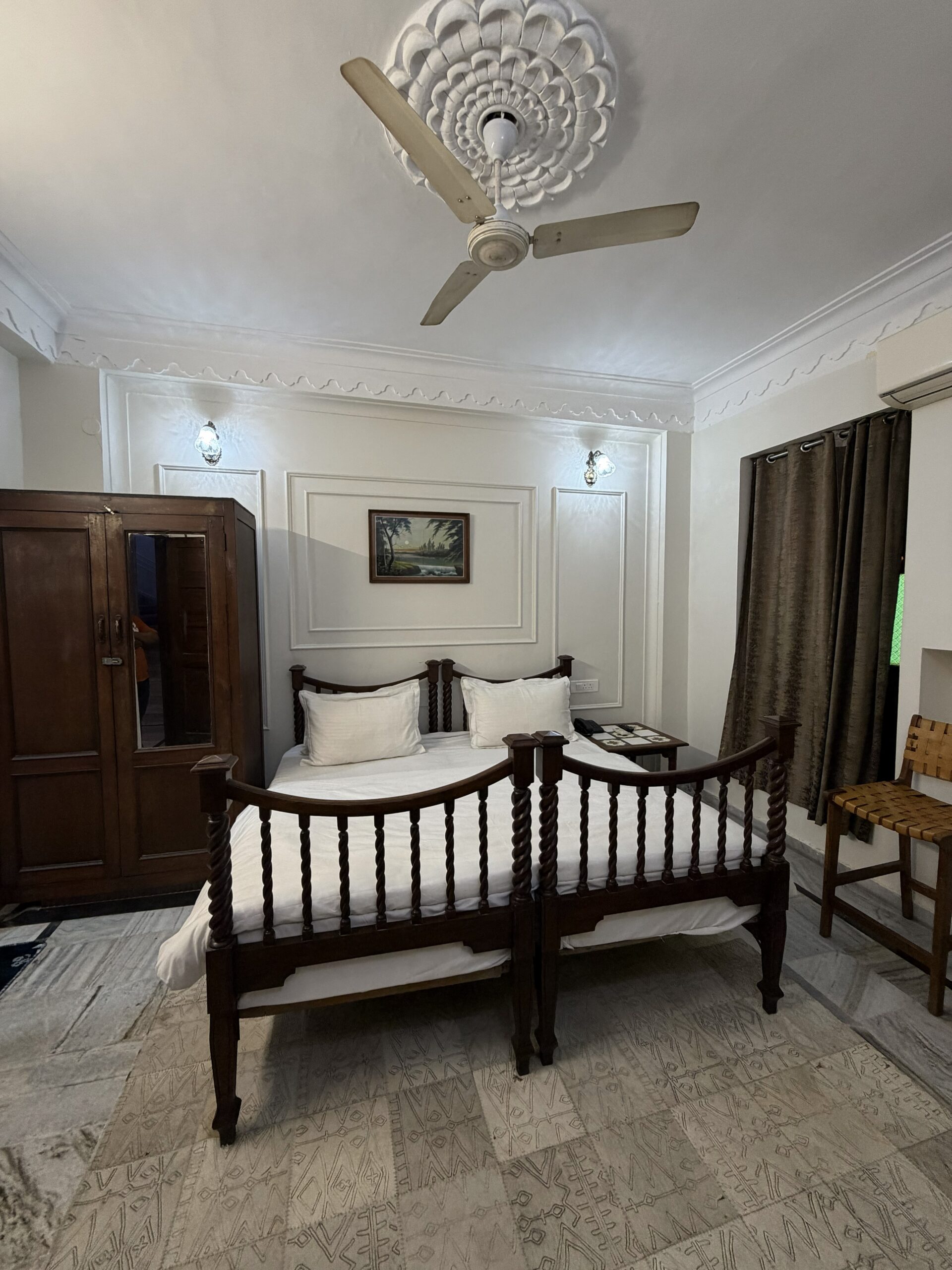 Deluxe room at Hotel Royale Plazo Jodhpur with wooden furniture, double bed, wardrobe and cozy interior decor